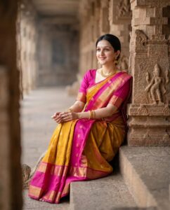 Indian Woman in Saree Seated by Historic Temple Architecture